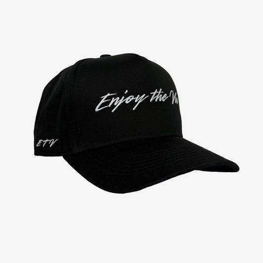 Black Snapback UPF 50+ Hat with Enjoy the Vu logo on front and ETV logo on side on a plain background