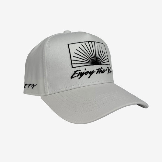 White snapback UPF 50+ hat with black logo on front and side on a plain background