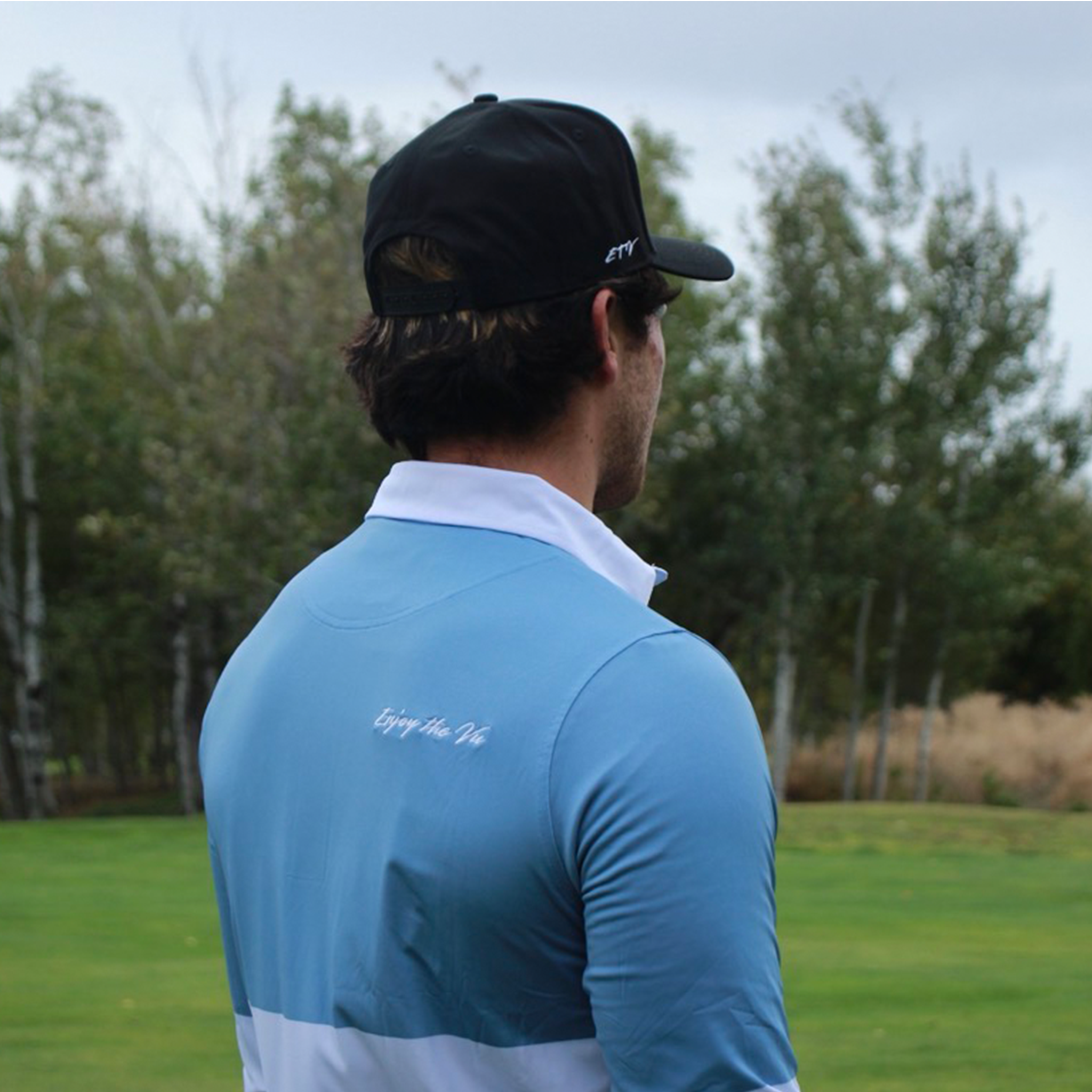 Man wearing the Marble Blue UPF 50+ long sleeve golf polo on an Okanagan golf course — Enjoy the Vu sun protection golf apparel