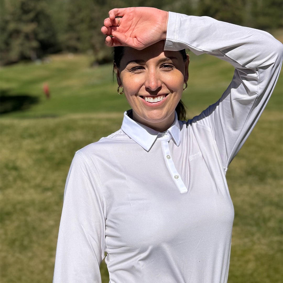 Woman wearing the Sahara UPF 50+ long sleeve golf polo on an Okanagan golf course — Enjoy the Vu sun protection golf apparel
